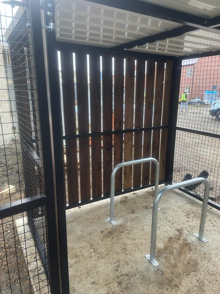 Galvanised and or Powder Coated Sheffield hoop bike rack installed on paving with two bikes locked
