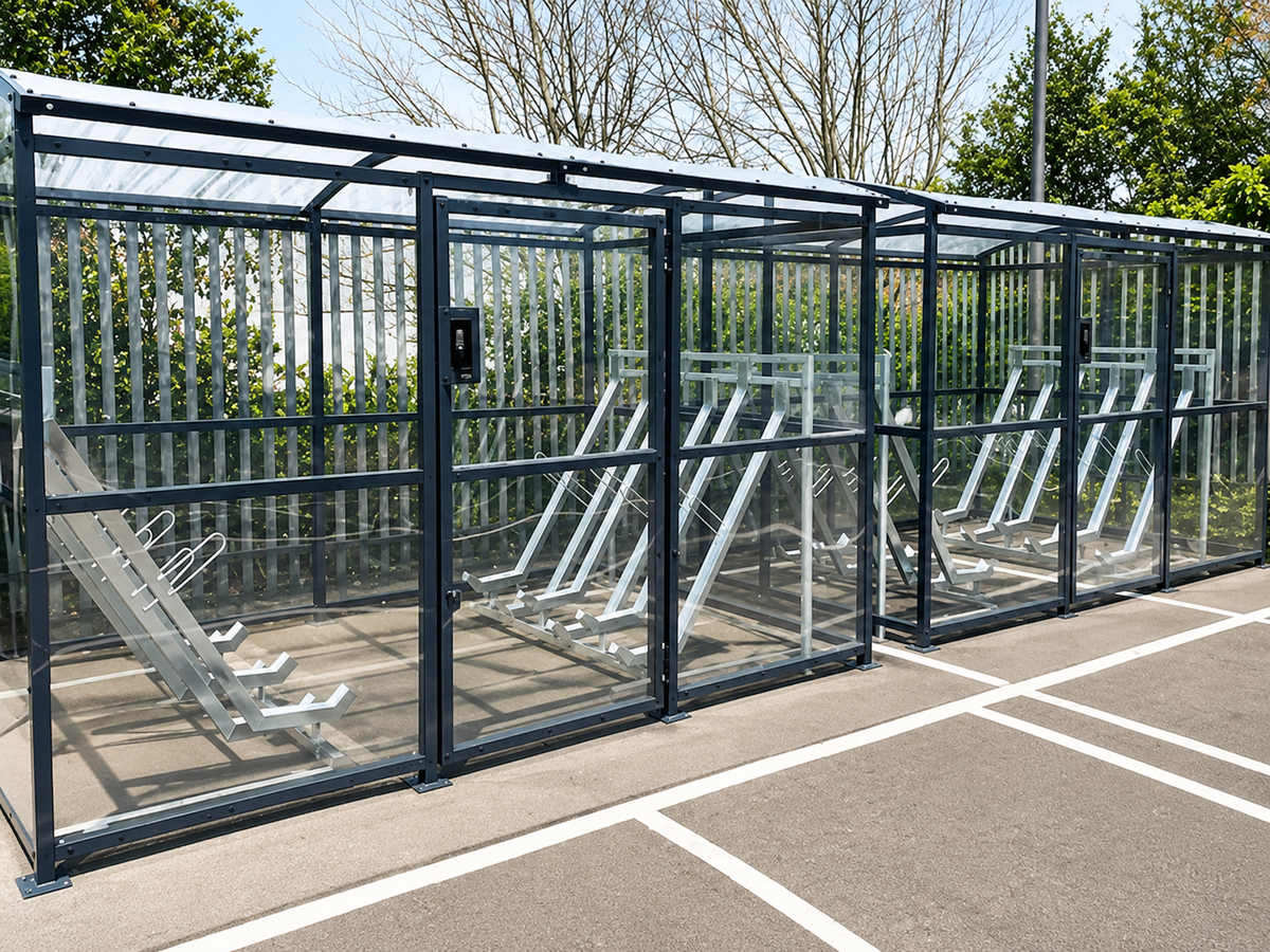 Secure multi-bay carriage cycle shelter with clear cladding and semi-vertical cycle racks