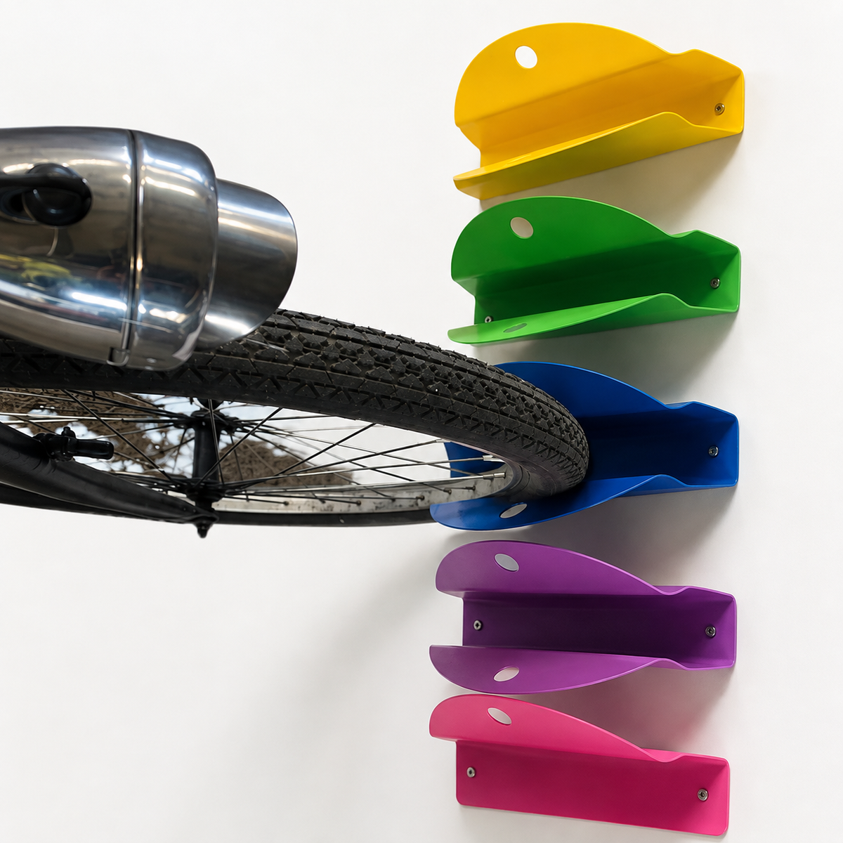 Square view of colourful Tacco wall mounted bike racks with a bicycle wheel supported by the blue rack