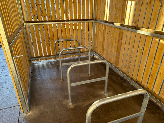 Galvanised Sheffield hoop cycle stand Installed in a Secure Timber Clad Shelter for commercial bike parking in the UK
