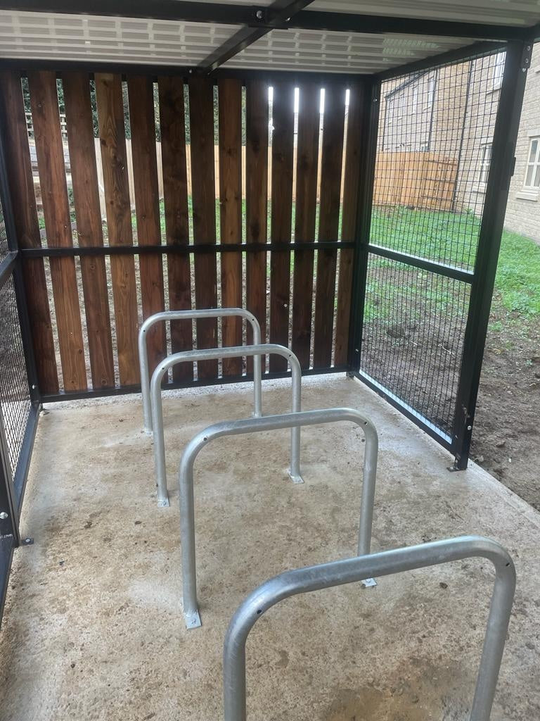 Galvanised and or Powder Coated Sheffield hoop bike rack installed on paving with two bikes locked