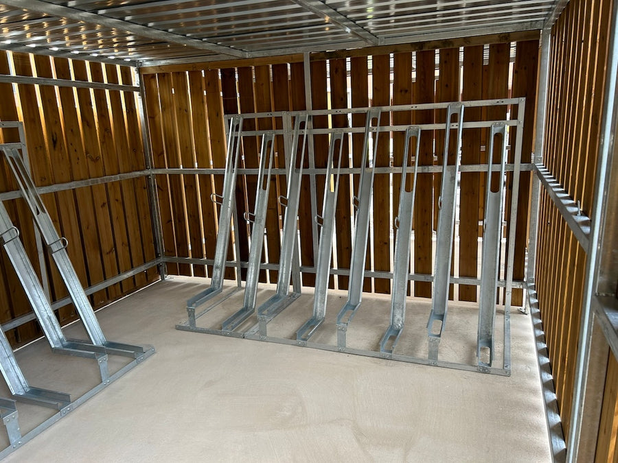 Semi-vertical bike racks installed in UK residential development secure cycle shelter